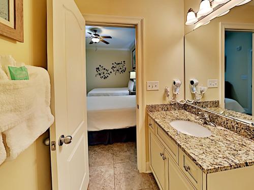 a bathroom with a sink and a mirror at Phoenix West II #2109 in Orange Beach