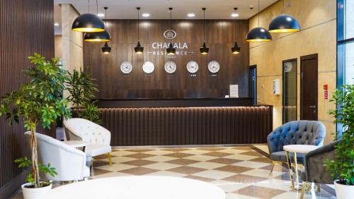 a waiting room with clocks on the wall at Chagala Residence Atyrau in Atyraū