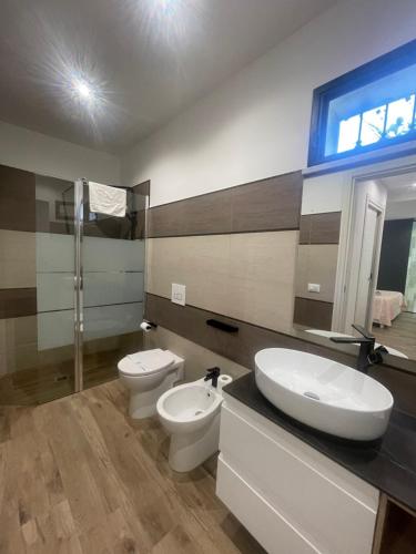 a bathroom with two toilets and a sink at Amantea Monument in Terrasini