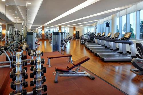 a gym with a bunch of treadmills and machines at Fashion Avenue Dubai Mall in Dubai