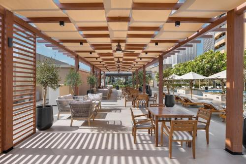 an outdoor patio with tables and chairs and umbrellas at Fashion Avenue Dubai Mall in Dubai