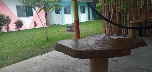 a wooden bird feeder with a rope in front of a house at OCEAN SURF in Mompiche