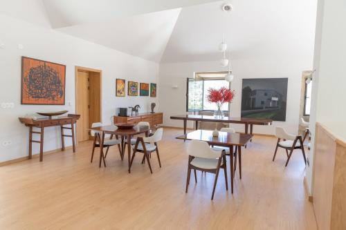 a dining room with wooden tables and chairs at QUINTA ALTO DO RIO in Cinfães
