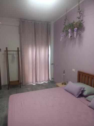 a bedroom with a large bed with a pink blanket at Le Stanze di Bimba in Terni