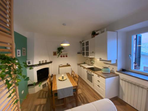 a kitchen with a table and a dining room at Casa di Lucy Umbria in Foligno