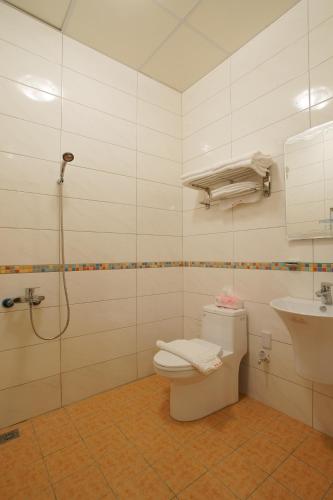 a bathroom with a toilet and a sink at Trip Village-Hulk's Homestay in Taitung City