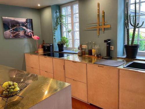 a kitchen with wooden cabinets and a counter top at L'Art de la fugue in Daverdisse