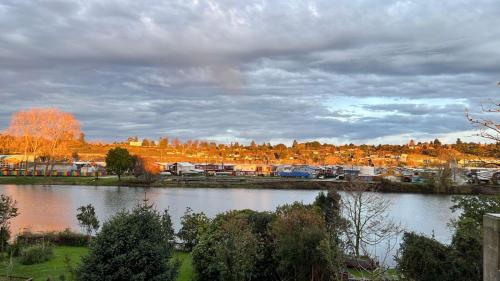 a view of a river with a town in the background at Hotel Boutique Casa Werner in Puerto Varas