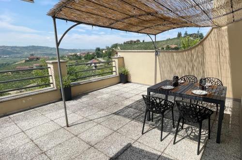 a table and chairs on a patio with a view at Casa da Bertu in Barbaresco