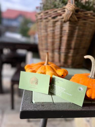 two pumpkins sitting on a table with a price tag at Zatyshok nad Prutom in Bukovel