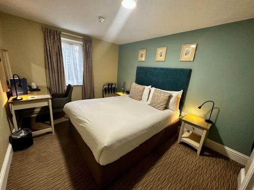 a hotel room with a bed and a green wall at The Merchant's House, BW Signature Collection in Salisbury