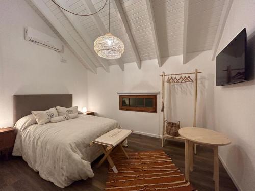 a bedroom with a large bed and a table at Oeste suites in Mendoza