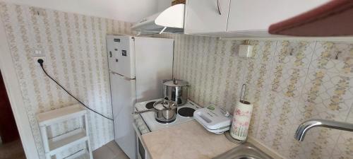 a small kitchen with a refrigerator and a sink at OIKIKA B10 in Artemida