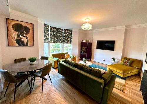 a living room with a couch and a table at Luxury Travel Emporium HG1 - 2 Luxury apartments with Parking Space - in town centre in Harrogate