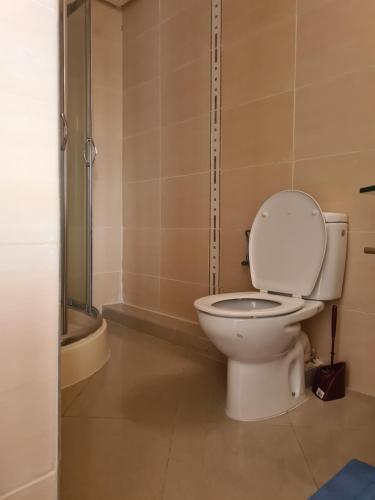a bathroom with a toilet and a shower at Asilah Marina Golf in Asilah