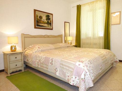 a bedroom with a bed and a dresser and a window at Apartments Ruby in Funtana