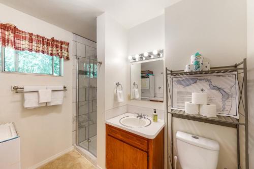 a bathroom with a sink and a toilet and a shower at Twin Lakes Gem in Rathdrum