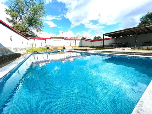 a large swimming pool with blue water at Gabala Regnum Family Villa in Gabala