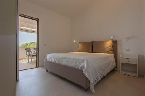 een slaapkamer met een bed en uitzicht op de oceaan bij Villino Marigia in Geremèas