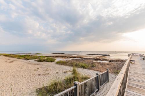 a boardwalk to the beach at a vacation home at Coastal Luxe Villa by the Beach in Hilton Head Island