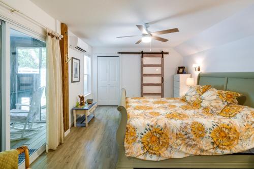 a bedroom with a bed and a sliding glass door at Kitty Hawk Vacation Rental with Pool and Hot Tub in Kitty Hawk