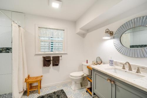 a bathroom with a sink and a toilet and a mirror at Kitty Hawk Vacation Rental with Pool and Hot Tub in Kitty Hawk