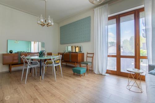 un soggiorno con tavolo e sedie e una cucina di Il Pino Marittimo a Viareggio