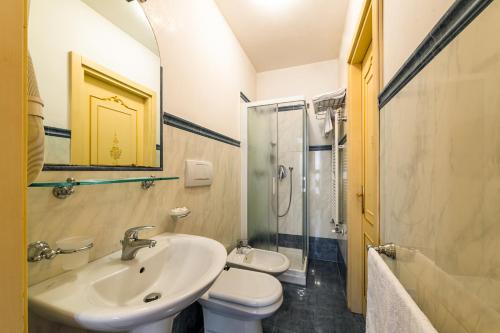 a bathroom with a sink and a toilet and a shower at Hotel Al Vagon in Venice