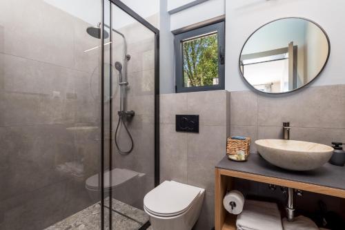 a bathroom with a shower and a toilet and a sink at PERUNIKA BED & BREAKFAST in Mošćenička Draga