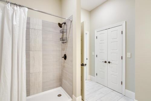a bathroom with a shower and a white door at Keestone Resort Apartment about 7 Mi to State Park 