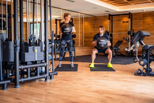 a man and a woman standing in a gym at Alpin Peaks in Turracher Hohe
