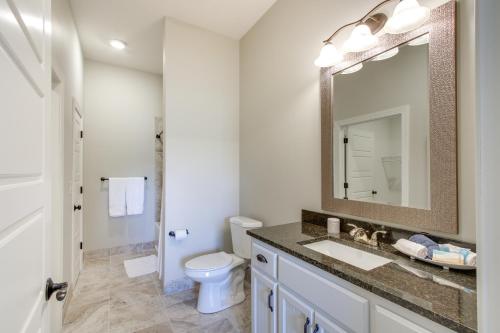 a bathroom with a sink and a toilet and a mirror at Resort Apartment in Loretto with Private Patio! 