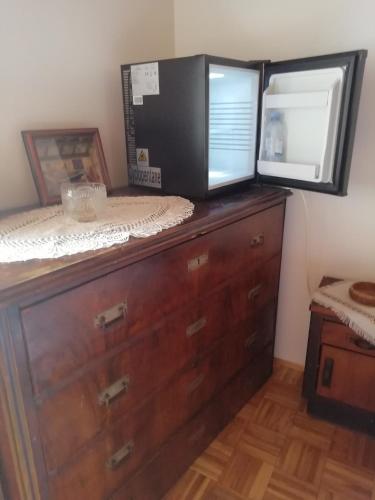 a wooden dresser with a microwave on top of it at Nice Room - Centar in Cres