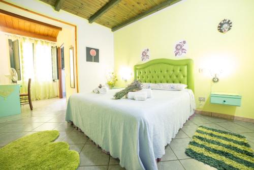 a bedroom with a large bed in a room with rugs at Sa Pramma in Baratili San Pietro