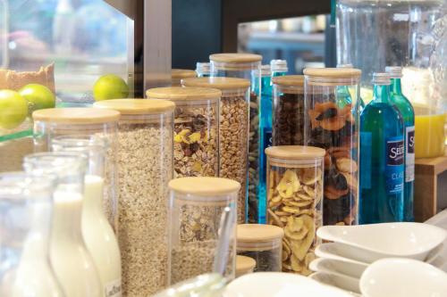 a group of glass jars filled with different types of seeds at SPREE. Hotel am Hafen in Lübbenau