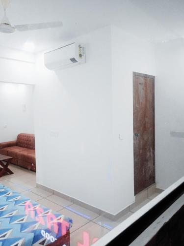 a room with a white wall with a door on it at THEKKUMPURAM RESIDENCY in Kondotti