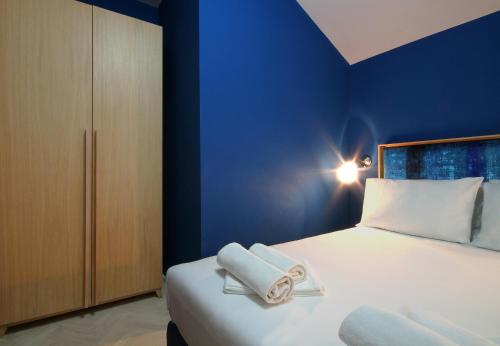 a bedroom with a bed with two towels on it at Panonija in Kotor