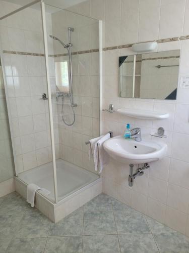 a bathroom with a shower and a sink at Gästezimmer Suppan in Hörbranz