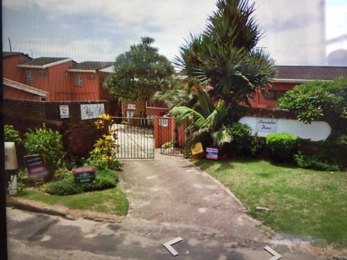 a driveway with a gate in front of a house at Step On the BEACH in Hibberdene