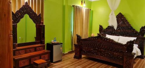 a bedroom with a bed and a large mirror at Toek Chha Temple Resort in Kampong Cham