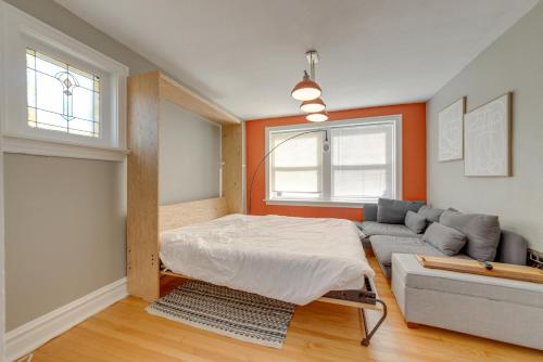 a living room with a bed and a couch at Inviting St Louis Apartment - Great Location! in Lemay