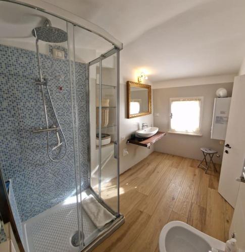 a bathroom with a shower and a toilet and a sink at Casa Myrtifolia in Todi