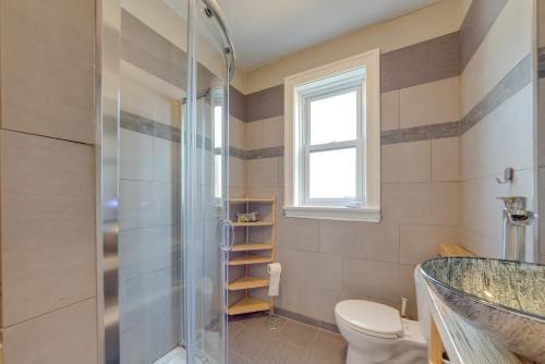 a bathroom with a shower and a toilet and a sink at Inviting St Louis Apartment - Great Location! in Lemay