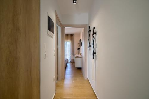 a hallway leading to a room with a bathroom at Yellow Lux Central Suite in Alexandroupoli