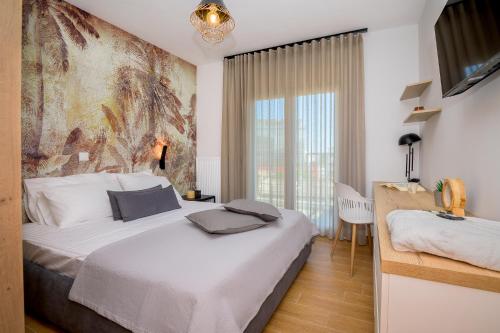 a bedroom with a bed and a large window at Yellow Lux Central Suite in Alexandroupoli