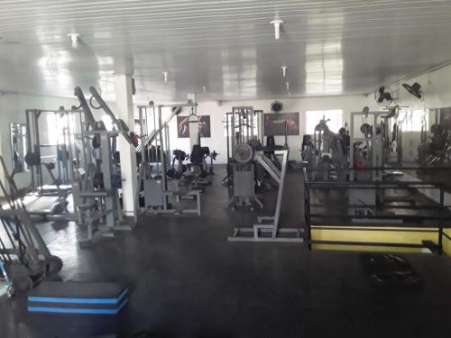 un gimnasio con mucho equipamiento en una habitación en Suíte 100m da praia e academia inclusa dias de semana, en Maceió