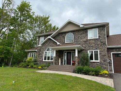 a home with a stone house at Lotus Moon in Charlottetown