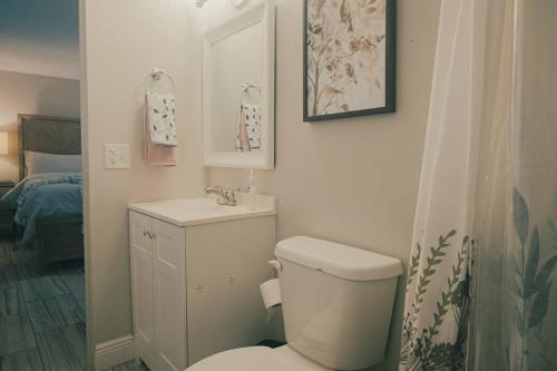 a small bathroom with a toilet and a sink at The Lake House (Tampa / LUTZ area) in Lutz