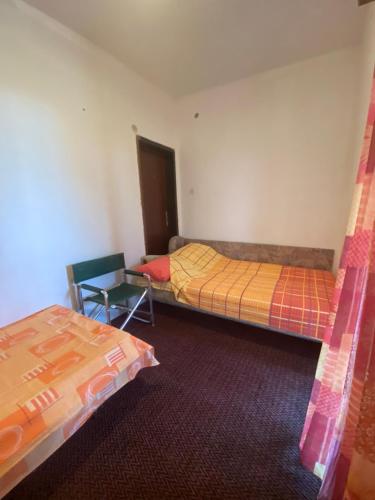 a room with two beds and a table in it at Victory Apartments in Sutomore