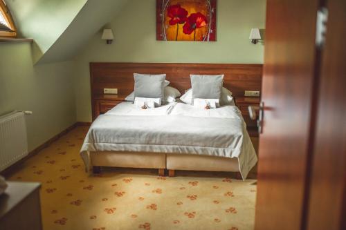 a bedroom with a large bed in a room at Hotel Rycerski in Czeladź